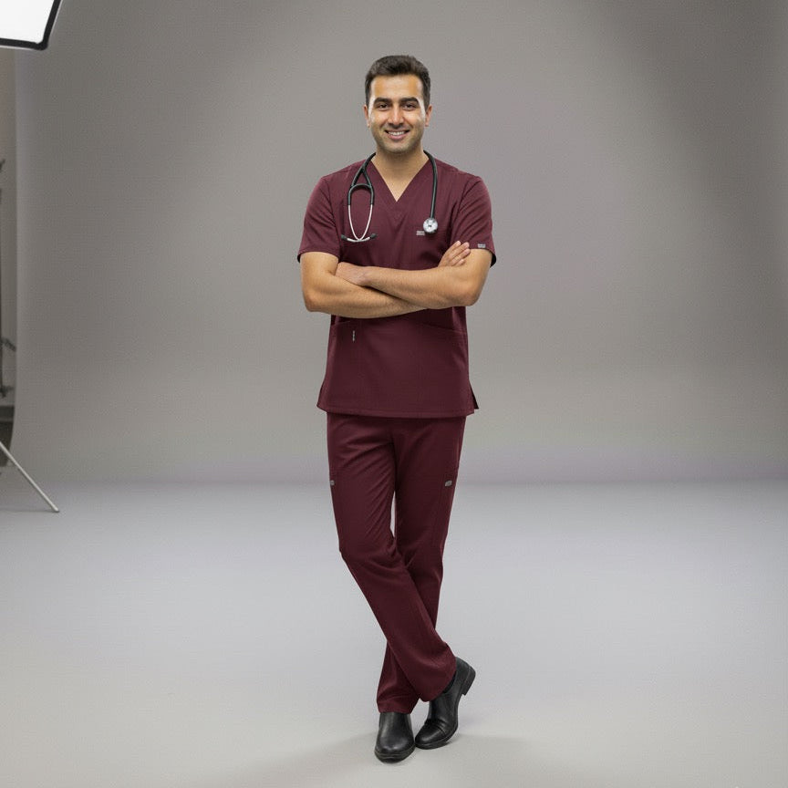 Person wearing maroon medical scrubs with a stethoscope in a studio setting