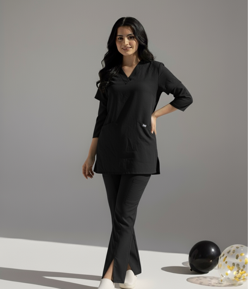 Woman wearing a black outfit with white shoes on a gray background