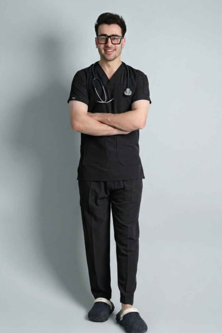 Person wearing black medical scrubs with a stethoscope on a gray background