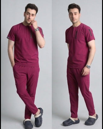 Man wearing a maroon outfit with black shoes on a gray background