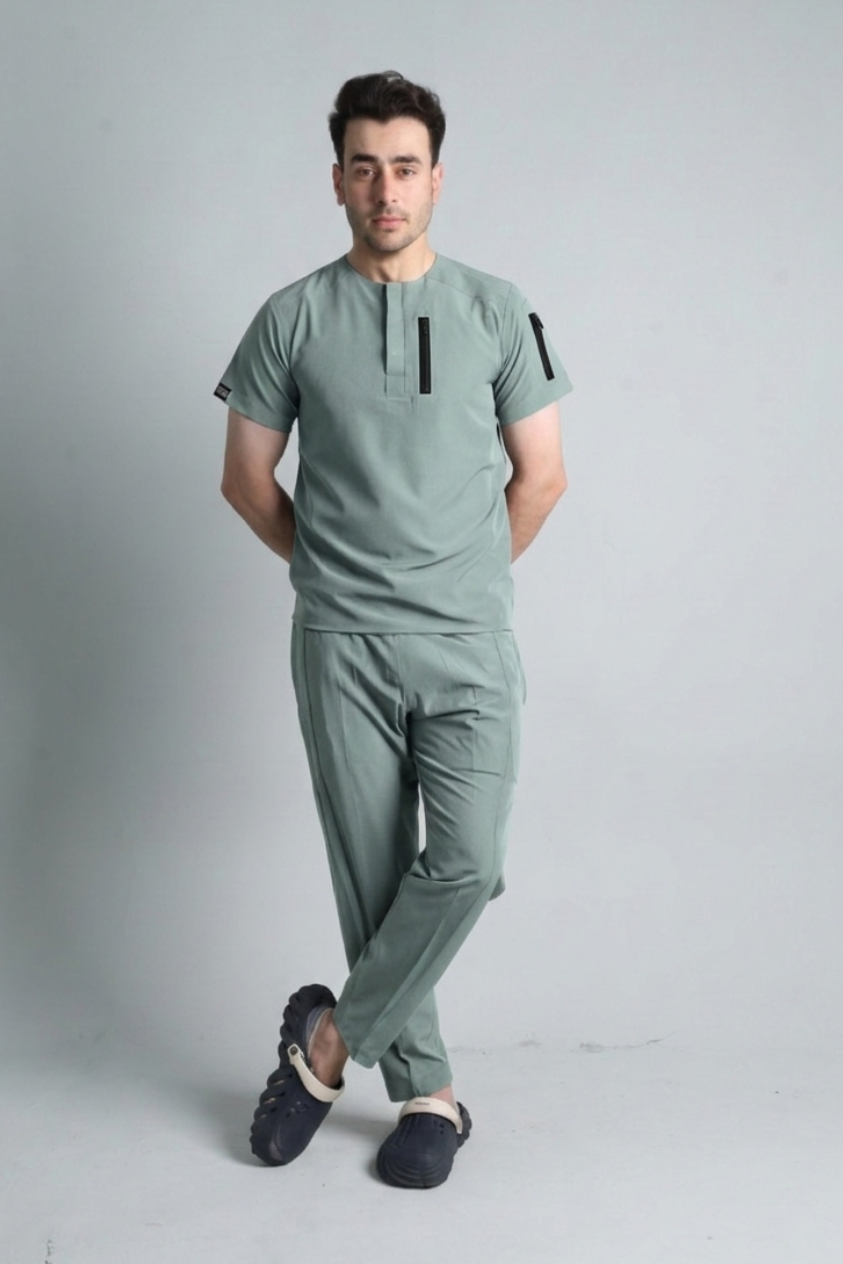 Man wearing a green outfit with black accents on a gray background