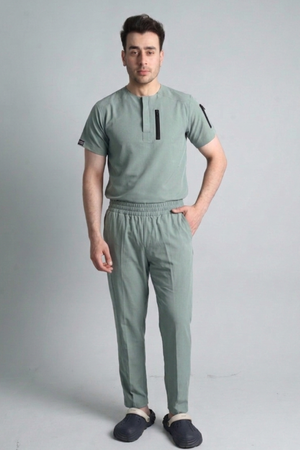 Man wearing a opal green outfit with a plain background