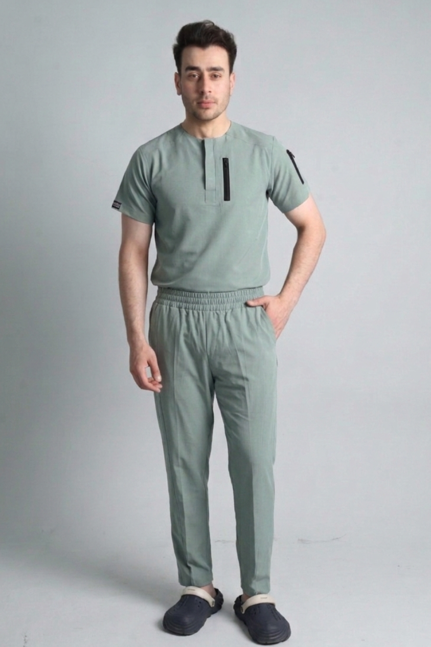 Man wearing a opal green outfit with a plain background
