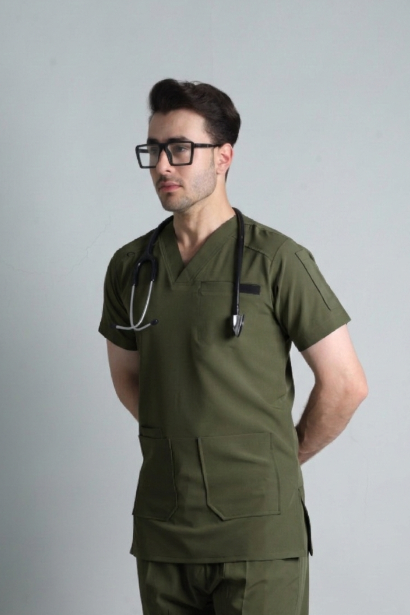 Person wearing green medical scrubs with a stethoscope on a gray background