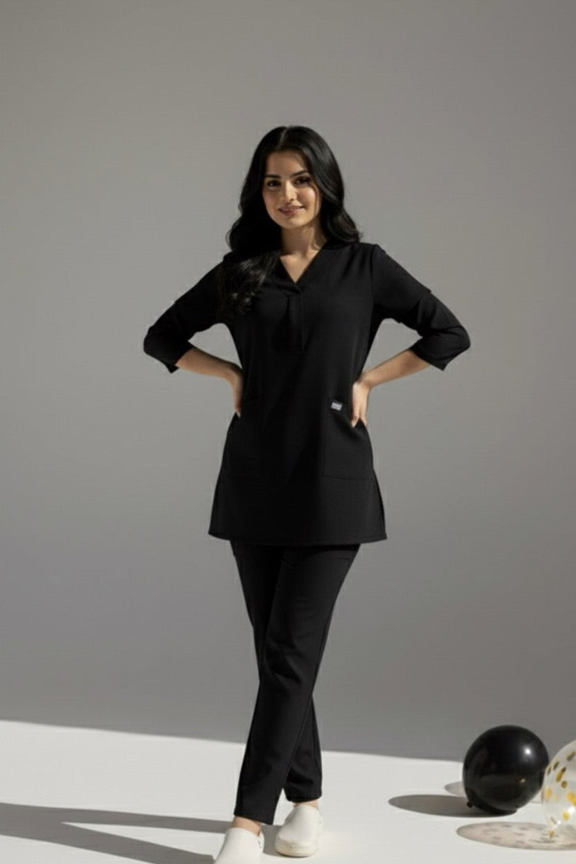 Woman wearing a black outfit with white shoes on a gray background