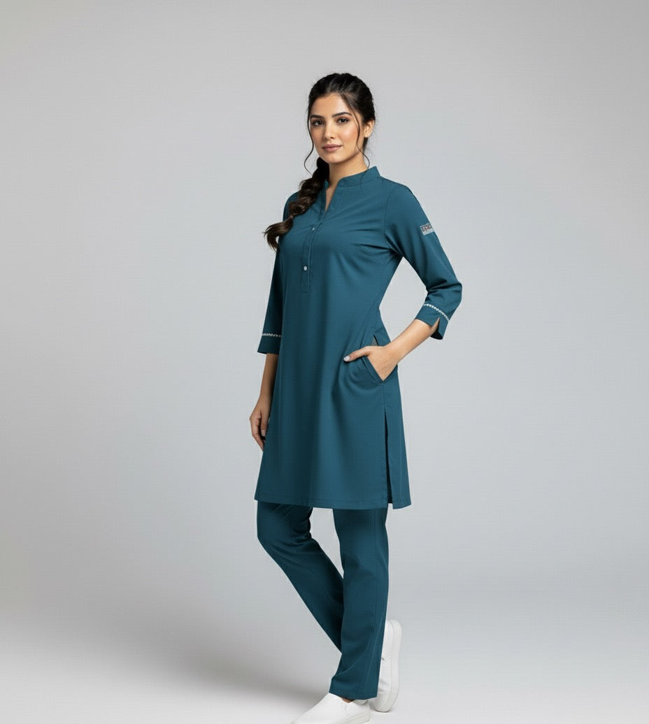 Woman wearing a teal medical scrub set on a gray background