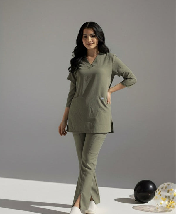 Woman wearing a green scrub on a gray background