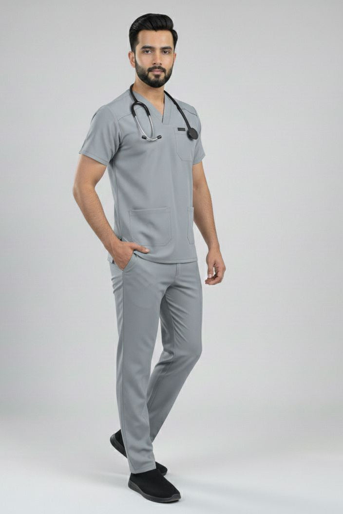 Man wearing a gray medical scrub set on a white background