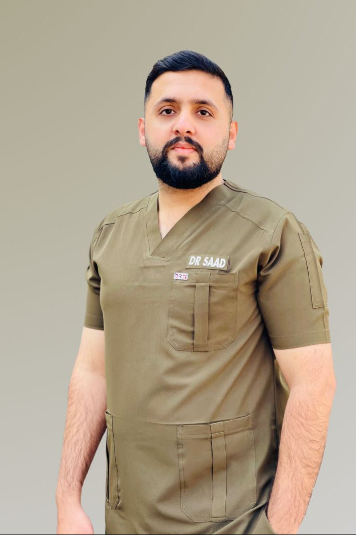 Man wearing a green scrub top with text on a plain background
