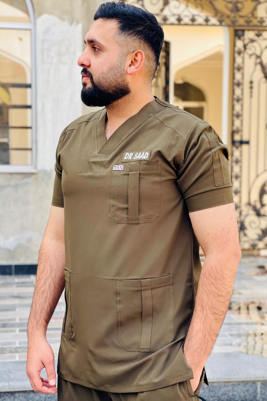 Man wearing a green scrub top with 'Dr. Sara' branding in an outdoor setting.