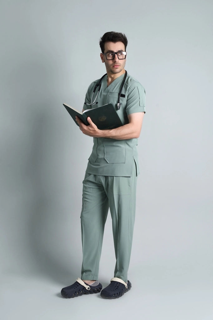 Person wearing medical scrubs holding a notebook against a plain background