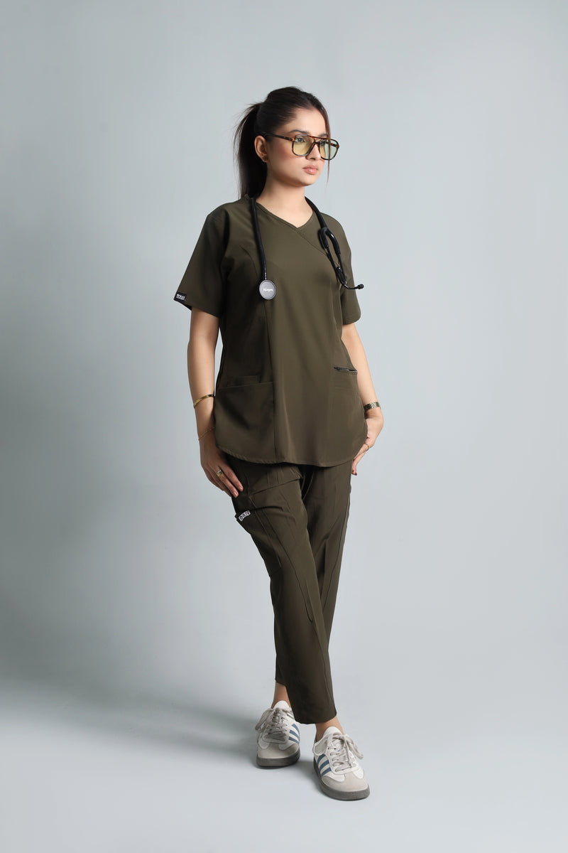 Person wearing a green scrub set with a backpack on a gray background