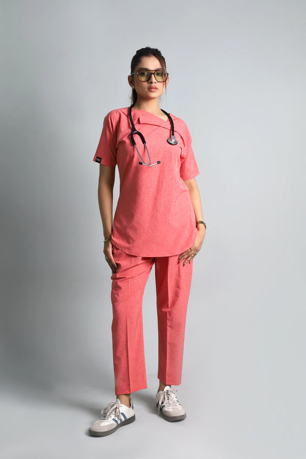 Person wearing a pink medical scrub set with a stethoscope on a gray background