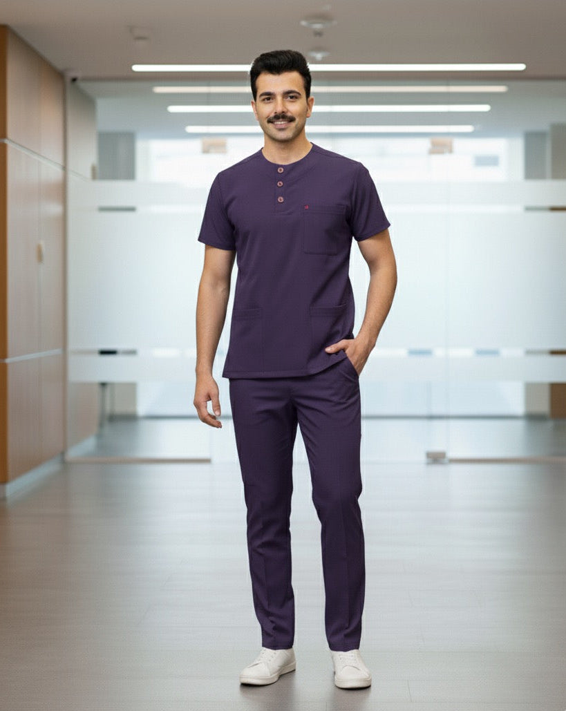 Man wearing a purple medical scrub set in a hospital corridor