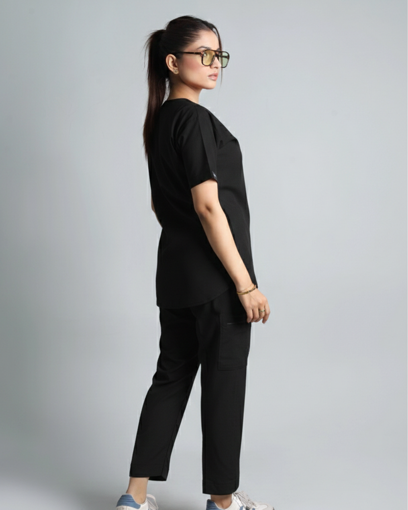 Person wearing a black outfit with Adidas shoes on a gray background